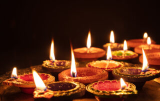 Diwali, Hindu festival of lights celebration. Diya oil lamps against dark background,