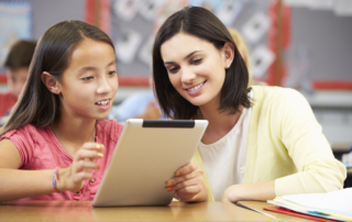 middle school student with teacher and iPad