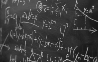 Maths formulas on chalkboard background