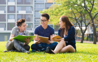 Group of students sharing ideas on the campus lawn. pre-college summer programs