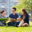 Group of students sharing ideas on the campus lawn. pre-college summer programs