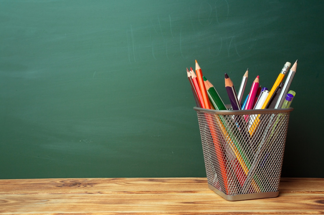 Last days of school, green chalkboard and colored pencils for coloring activities
